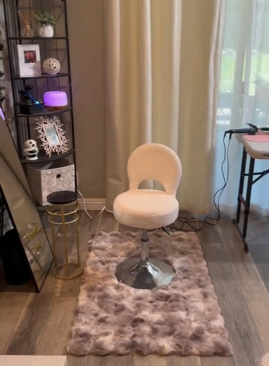 Plush white styling chair on a faux-fur rug in the studio